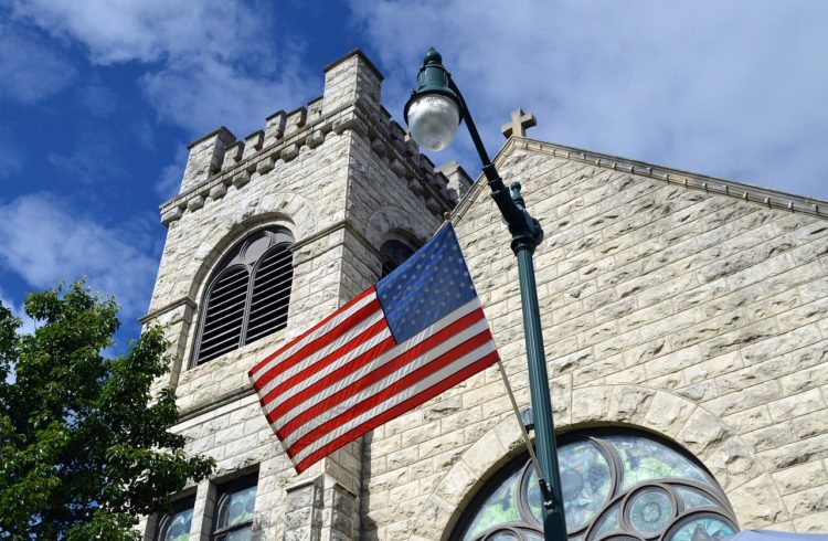 American flag waves in front of an American church