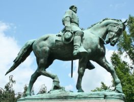 green statue of a man on a horse