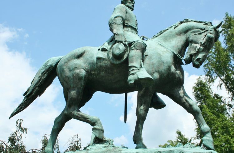 green statue of a man on a horse